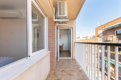 a balcony of a building with a window and a heater at Cadillac Cornella Cozy 15 Min Airport Barcelona in Cornellà de Llobregat