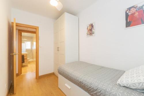 a small bedroom with a bed and a bathroom at Cadillac Cornella Cozy 15 Min Airport Barcelona in Cornellà de Llobregat