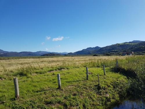 a fence in the middle of a field at 48 Glan Y Mor in Fairbourne