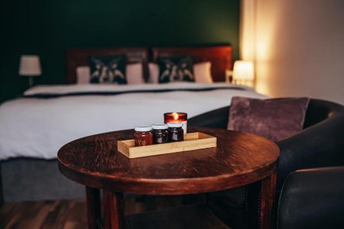 a room with a bed and a table with jars on it at Apartmány Rudík in Železná Ruda