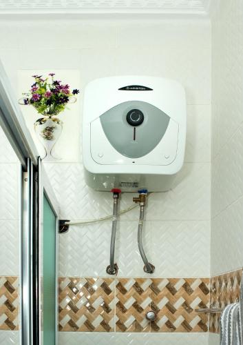 a hair dryer on the wall of a bathroom at Yussals Luxury Apartment in Kokrobite