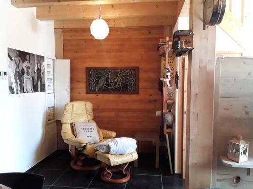 a room with a chair with a book on it at La Courtine 3 in Verchaix