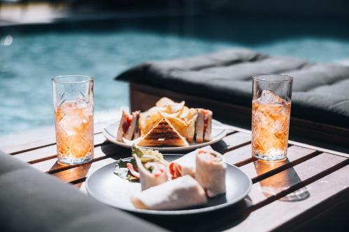 a table with plates of food and drinks on it at Seascape Luxury Residences in Agia Pelagia
