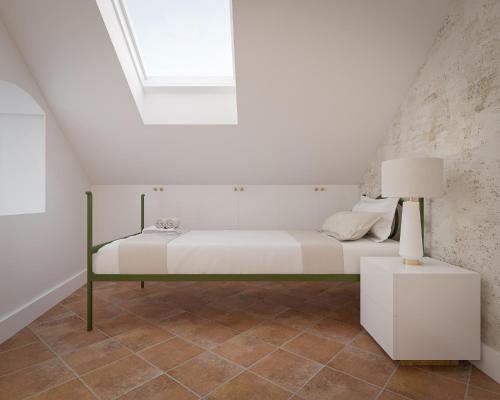 a bed in a white room with a window at Vila Perast Boutique Hotel in Perast