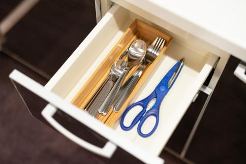 a white drawer with silver utensils in it at HIZ HOTEL Kyoto-Nijo Castle in Kyoto