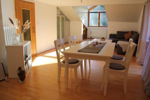 a dining room and living room with a table and chairs at Haus Lina in Oberjoch