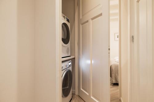 a laundry room with two washer and dryer at Leidse Square 5 star Luxury Apartment in Amsterdam