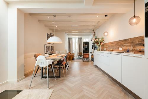 a kitchen and dining room with a table and chairs at Leidse Square 5 star Luxury Apartment in Amsterdam
