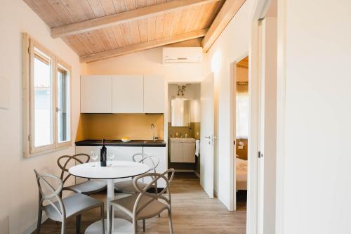 a kitchen and dining room with a table and chairs at Natural Village Resort in Porto Potenza Picena