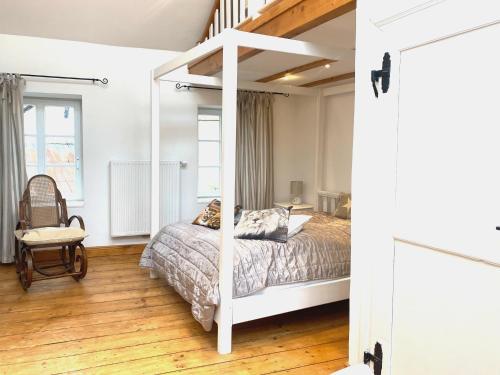 a bedroom with a bed with a white bed frame at Living in History - Modern Country Cottage in Dudeldorf