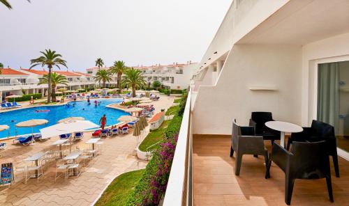 a view of a swimming pool and a resort at Globales Los Delfines in Cala en Blanes