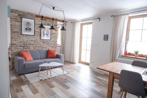 a living room with a couch and a brick wall at Jachovka in Nová Ves v Horách