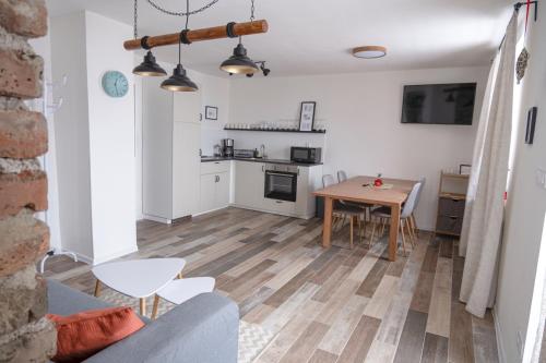 a living room with a table and a kitchen at Jachovka in Nová Ves v Horách