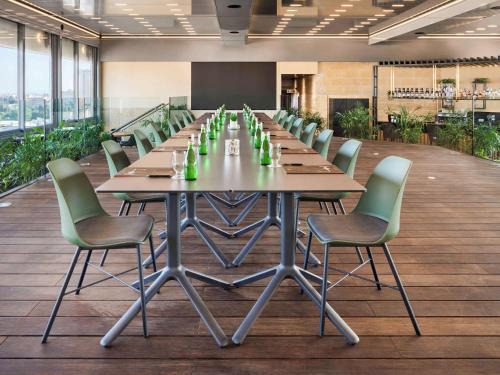 a large conference room with a long table and chairs at ibis Jerusalem city Center - An AccorHotels Brand in Jerusalem