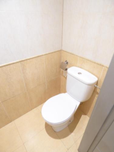 a bathroom with a white toilet in a room at Moderno in Barcelona