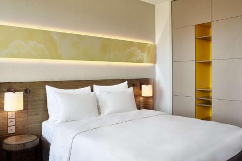 a hotel room with a bed and a lamp at Radisson Blu Hotel, Lyon in Lyon