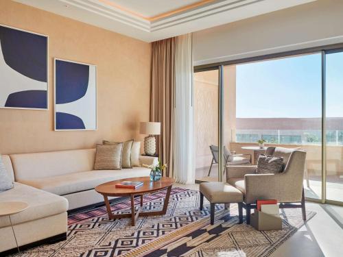 a living room with a couch and a table at Fairmont Taghazout Bay in Taghazout