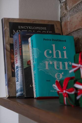 three books sitting on top of a shelf at Jachovka in Nová Ves v Horách