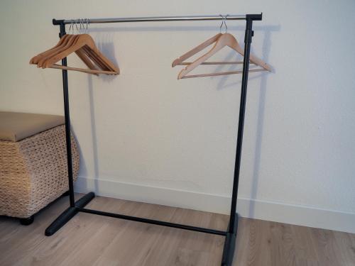 a black stand with hangers in a room at Superbe vue mer avec accès direct plage et parking in Le Barcarès