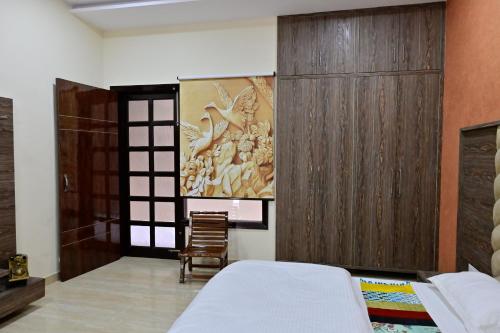 a bedroom with a bed and a wooden wall at Ideal Home stay in Amritsar