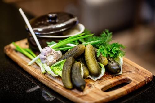 a bunch of vegetables on a wooden cutting board at Hotel Grand City Wrocław in Wrocław