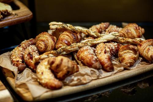 a tray of different types of pastries and croissants at Hotel Grand City Wrocław in Wrocław