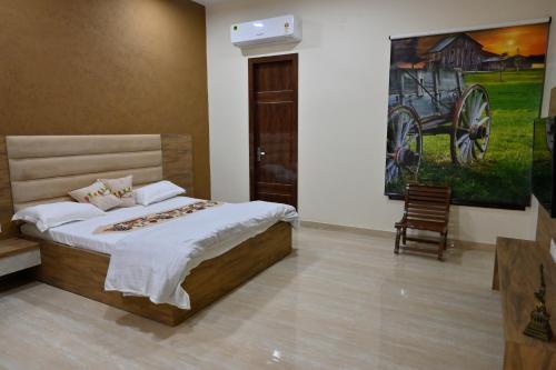 a bedroom with a bed and a painting on the wall at Ideal Home stay in Amritsar