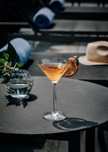 a drink in a glass sitting on a table at Commune by the Great Wall, in the Unbound Collection by Hyatt in Yanqing