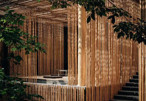 a room with a wooden wall with stairs and trees at Commune by the Great Wall, in the Unbound Collection by Hyatt in Yanqing