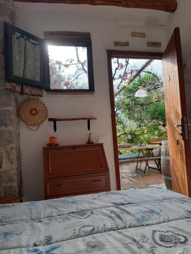 a bedroom with a bed and a door to a patio at S'Imbragu Farm B&B in Tortolì