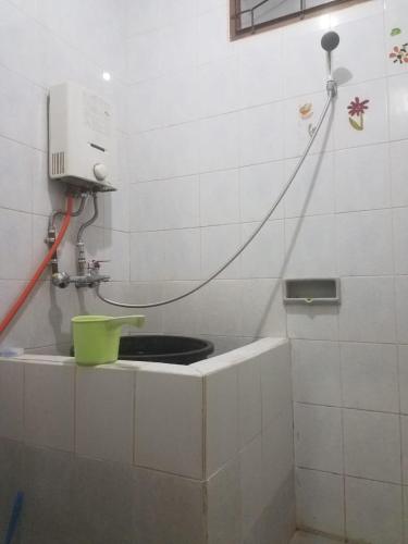 a bathroom with a sink with a hose at Villa Denisa in Tlekung