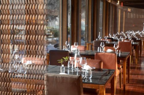 a row of tables and chairs in a restaurant at Commune by the Great Wall, in the Unbound Collection by Hyatt in Yanqing