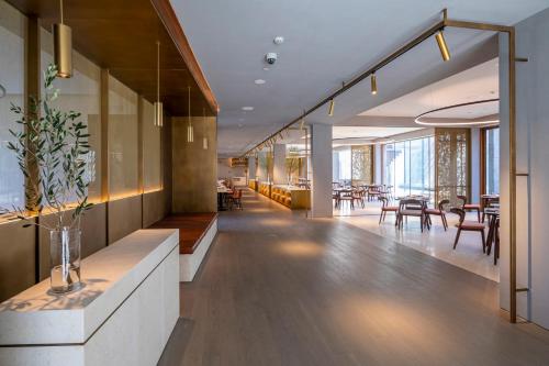 a lobby of a building with tables and chairs at Commune by the Great Wall, in the Unbound Collection by Hyatt in Yanqing