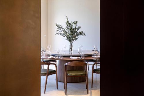 a dining room table with a vase of flowers on it at Commune by the Great Wall, in the Unbound Collection by Hyatt in Yanqing