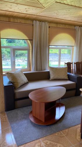a living room with a couch and a table at Садиба "Джерело" in Yaremche