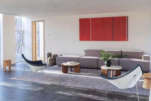 a living room with a couch and chairs at Commune by the Great Wall, in the Unbound Collection by Hyatt in Yanqing