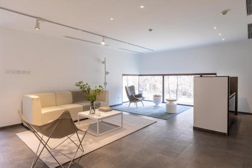 a living room with a couch and a table at Commune by the Great Wall, in the Unbound Collection by Hyatt in Yanqing