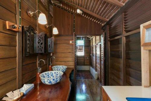 a bathroom with two sinks in a train car at tanabendang banglos in Pantai Cenang