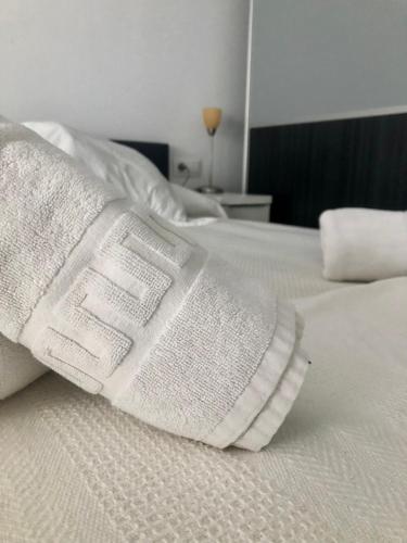 a pair of white socks sitting on top of a bed at Estudios en la playa in Valencia