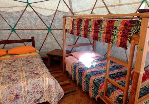 a bedroom with two bunk beds in a yurt at La Pacha Hostel in Barichara