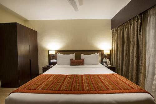 a bedroom with a large bed in a hotel room at The Fern Sardar Sarovar Resort Kevadia, Gujarat in Kevadia