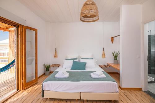 Posteľ alebo postele v izbe v ubytovaní Sirens beach houses