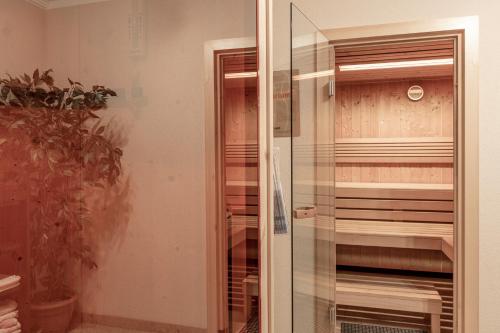 a glass door leading into a room with a closet at Apart Felsenhof in Längenfeld
