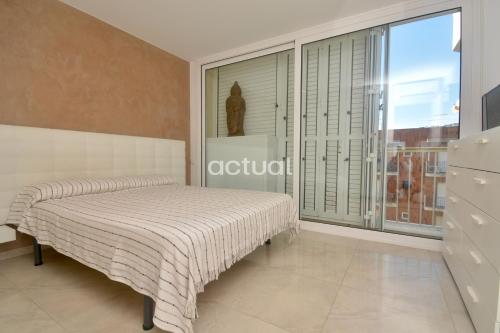 1 dormitorio con cama y ventana grande en Catalunya A-3, en Platja d'Aro