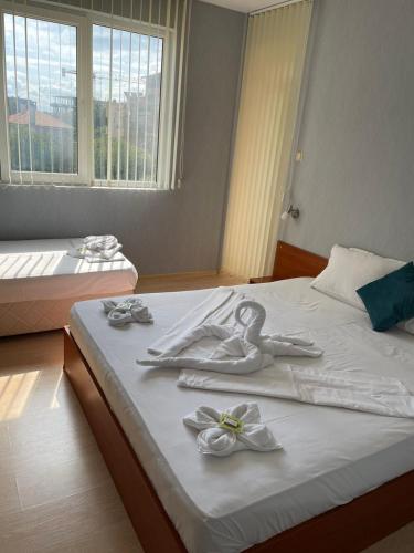 a bedroom with a bed with white towels on it at Sea Horse in Burgas City