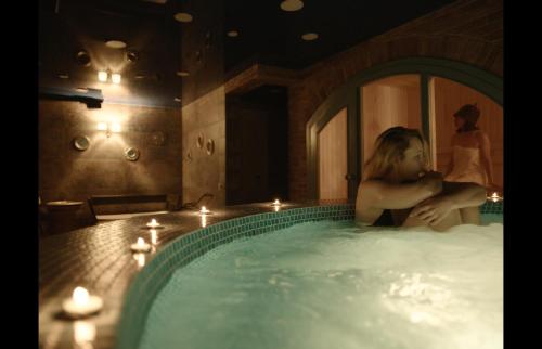 a woman sitting in a bath tub in a room at Ati Ambavi Botique Hotel Gudauri in Gudauri