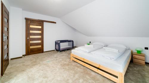 a bedroom with a bed and a tv in it at Dom Sarnia 37, Sun & Snow in Karpacz