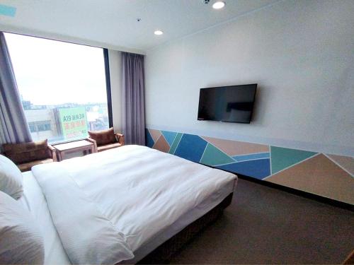Ένα ή περισσότερα κρεβάτια σε δωμάτιο στο Hotel J Taoyuan