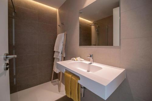 a bathroom with a white sink and a shower at Kora Nivaria Beach in Abades