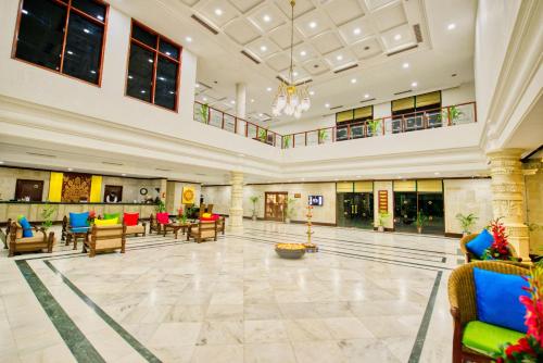 a lobby with chairs and tables in a building at Clarks Khajuraho in Khajurāho